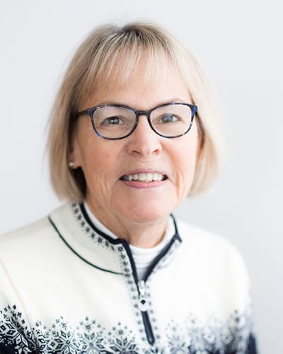 Smiling elderly woman wearing a festive sweater