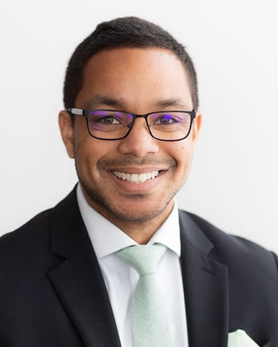 Smiling staff member in formal attire