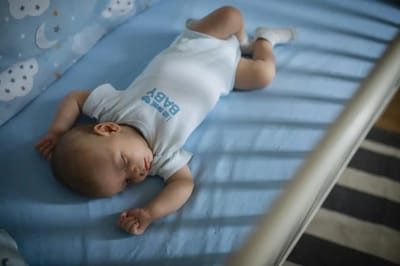 A baby sleeping in a crib