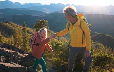 Two people hiking in a mountainous landscape