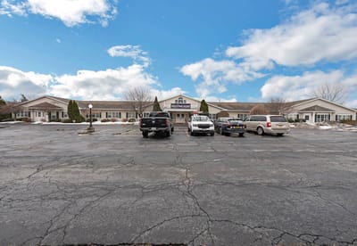 Exterior view of the facility with parking lot and entrance