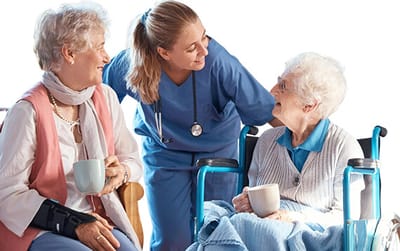 Two residents enjoying coffee while chatting with a nurse
