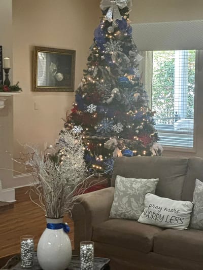 Cozy decorated interior with Christmas tree and seating area