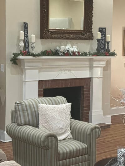 Decorative lounge area with a fireplace and armchair