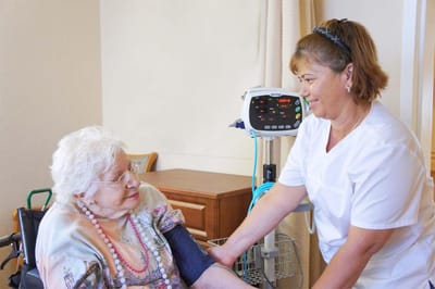 Nurse assisting resident in a care facility