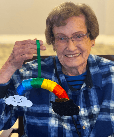 Resident displaying a colorful craft project