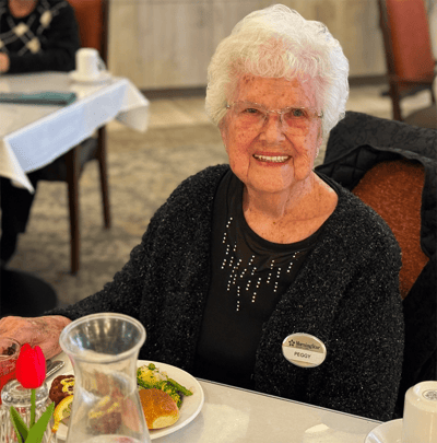 Resident enjoying a meal in the dining area
