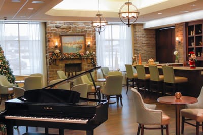 Interior common area with piano and festive decor