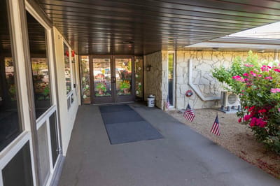 Entrance of Meadow View Nursing & Rehabilitation facility with flags