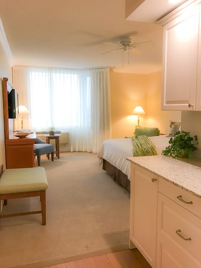 Bright and inviting resident room with a bed and seating area