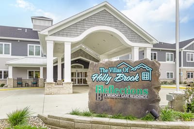 Exterior view of the Villas of Holly Brook with sign