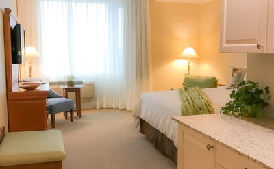 Bright and inviting resident room with a bed and seating area