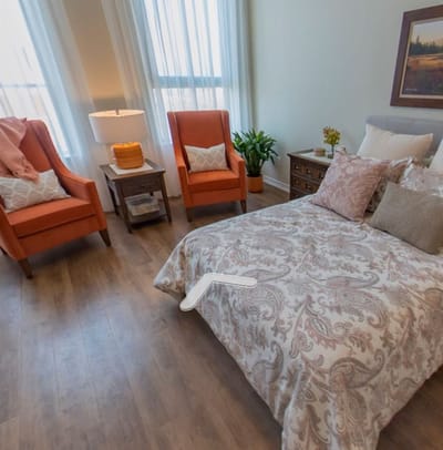 Brightly decorated resident room with cozy seating
