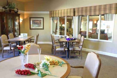 Bright common area with tables and chairs set up