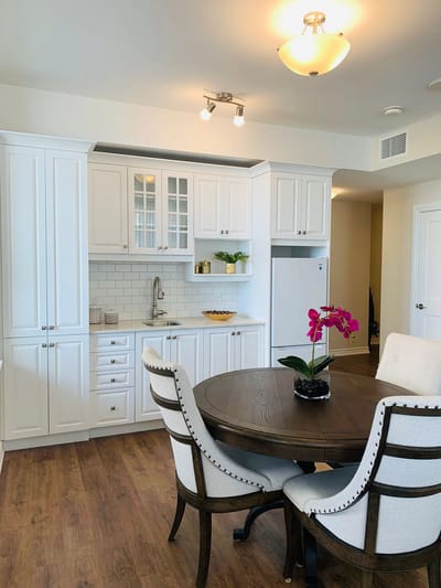 Bright kitchen area with a dining table and flower centerpiece