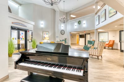 Bright common area with a piano and seating
