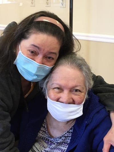 Two residents sharing a joyful moment indoors