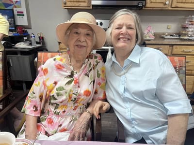 Two residents smiling together in a common area
