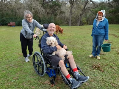 Residents enjoying time outdoors with a dog