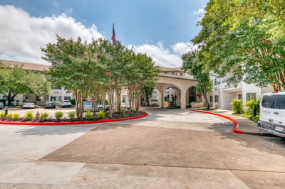 Entrance of Solstice Senior Living at Austin with trees and landscaping