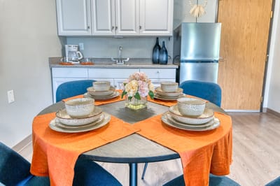 Cozy dining area set with dishes and flowers
