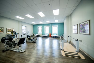 Rehabilitation gym with exercise equipment and open space