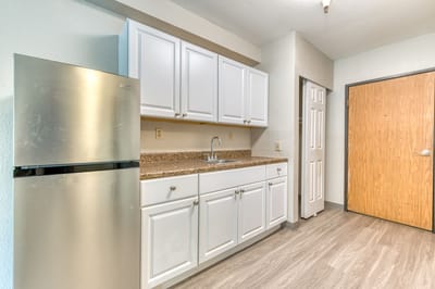 Interior kitchen space with cabinets and appliances