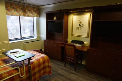 Private resident room with a bed and desk