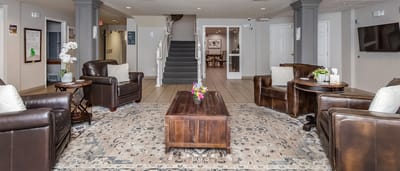 Bright common area with seating and decorative flowers