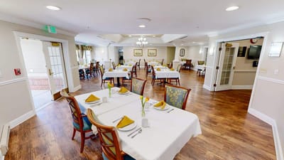 Dining room with neatly set tables and chairs