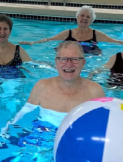 Seniors enjoying a water activity in a pool