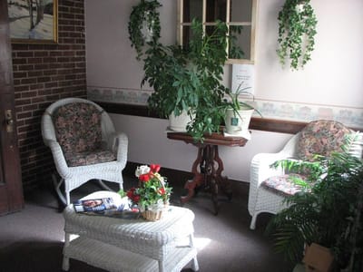 Cozy lounge area with wicker chairs and plants