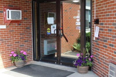 Entrance with potted flowers at Montello Manor