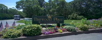 Signage with the name of Thirwood Place amidst flowers