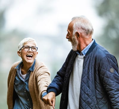 Seniors enjoying a walk outdoors, smiling