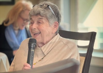 Resident enjoying an activity with a microphone