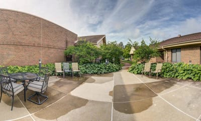 Outdoor seating area with greenery and pathways
