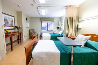 A bright and comfortable resident room with two beds