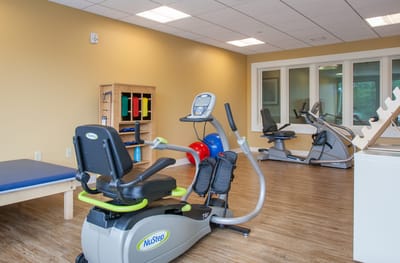 Therapy room with exercise equipment and bright walls