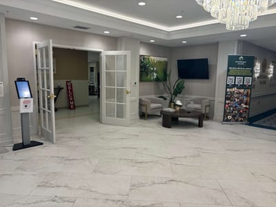 Bright lobby area with seating and welcome signage