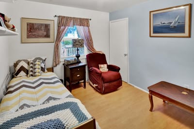 Cozy resident room with a bed and armchair