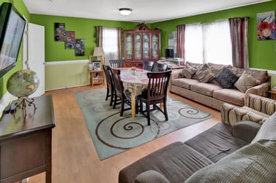 A well-furnished common area with a dining table