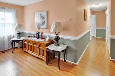 Brightly lit interior hallway with wooden furniture