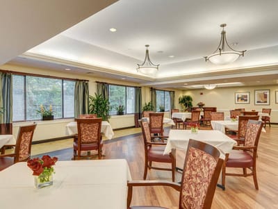 Bright dining room with tables and chairs for residents