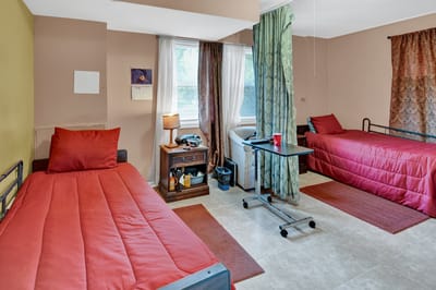 Shared resident room with two beds and curtains