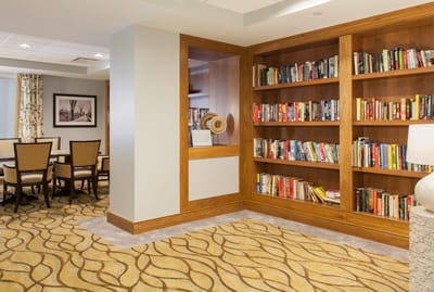 Interior view of a cozy common area with bookshelves