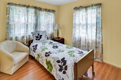 Brightly lit private resident room with decor