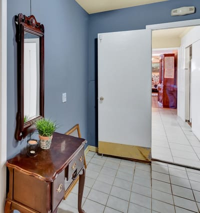 Entryway of an assisted living facility with a decorative mirror