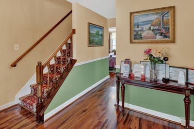 Interior hallway with decorative staircase and art