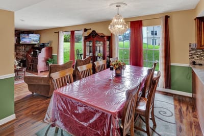 Dining area with a large table and chandelier